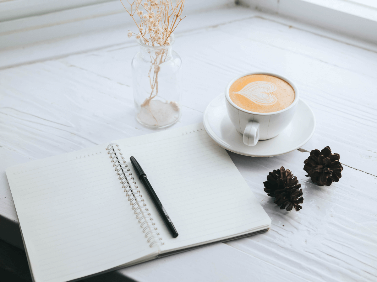 Open weight loss journal with pen and tea on a desk – promoting mindful tracking instead of app notifications